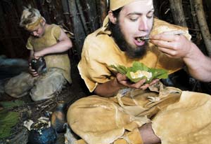 In buckskins eating from a leaf.