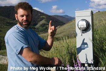 Thomas Elpel at electrical meter running backward from solar power.