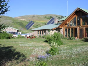 Elpel's stone and log house with solar panels.