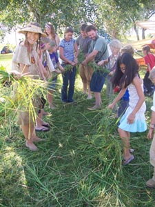 Group effort making big grass rope.